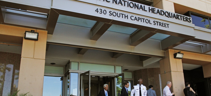 People stand outside the Democratic National Committee (DNC) headquarters in Washington, Tuesday, June 14, 2016.