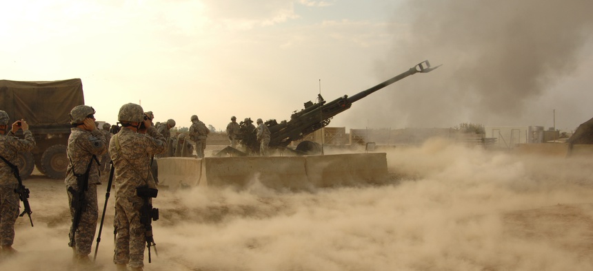 U.S. troops fire rounds to calibrate an M777 howitzer on Forward Operating Base Warhorse, Iraq, Dec. 8, 2009.
