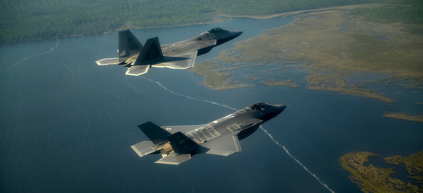 An Air Force F-22 Raptor (left) flies with an F-35 Joint Strike Fighter over Florida.