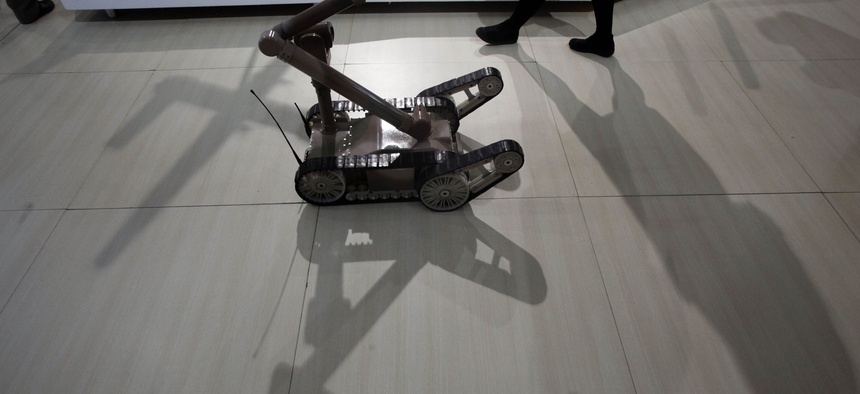 A remote controlled robot cast a shadow at an exhibition on police equipment and anti-terror technologies held in Beijing, China, Thursday, May 19, 2011.