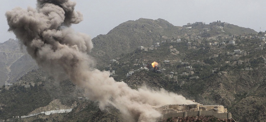 Smoke rises from al-Qahira castle, an ancient fortress that was recently taken over by Shiite rebels, as another building on the Saber mountain, in the background, explodes after Saudi-led air strikes in Taiz city, Yemen, in May 2015.