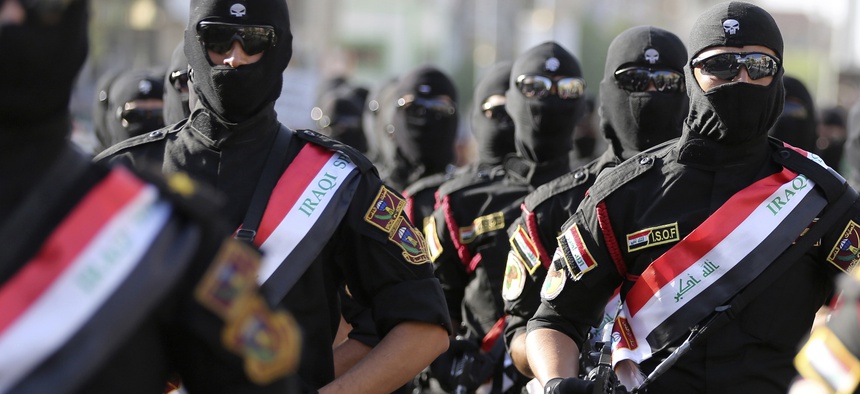 Iraqi security force members parade in Baghdad, Iraq, Thursday, July 14, 2016.
