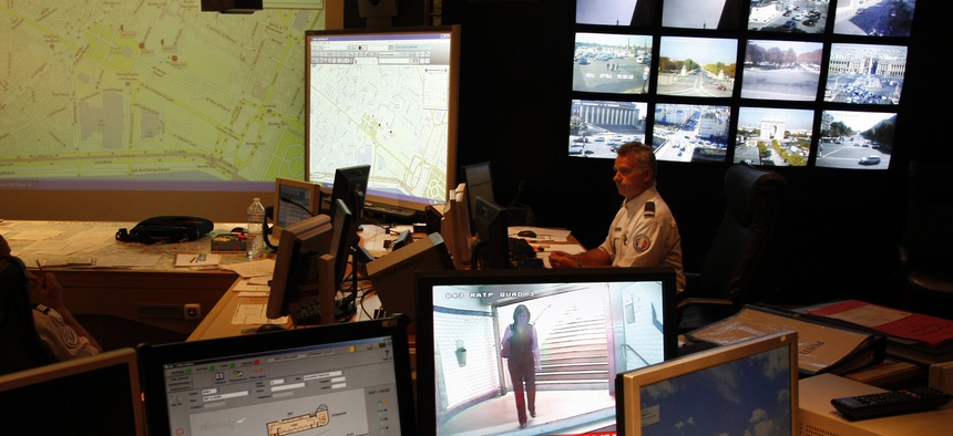 French Police officer checks on video monitors and computer screens in the underground security central command center of the Paris prefecture, in Paris, Wednesday Sept. 22, 2010.