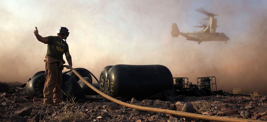 A bulk fuel specialist with Marine Medium Tiltrotor Squadron 365 (Reinforced), 24th Marine Expeditionary Unit, prepares to fuel an MV-22B Osprey at Camp Lemonnier in Djibouti, Feb. 20, 2015.