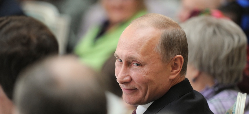 Russian Prime Minister Vladimir Putin smiles as he attends a meeting with retirees in the Kremlin in Moscow, Thursday, Nov. 17, 2011.