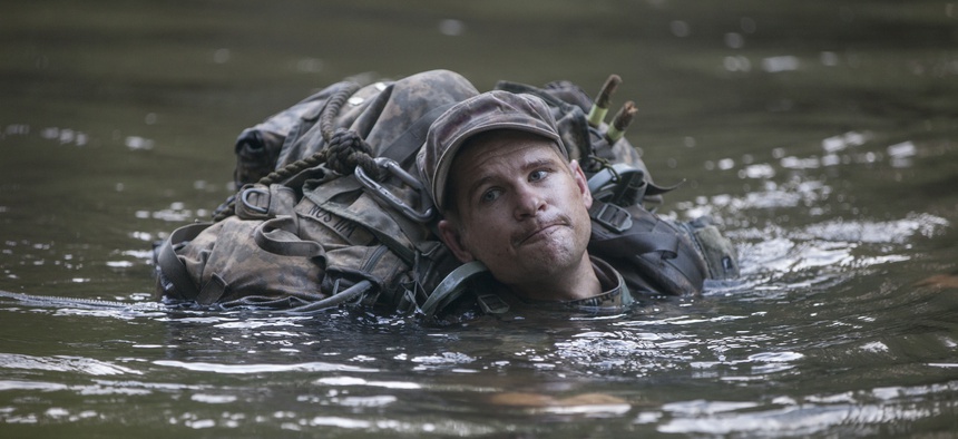 A U.S. Army Ranger student, assigned to the Airborne and Ranger Training Brigade, crosses a river using a single line rope bridge at Camp Rudder, Eglin Air Force Base, Fla., July 7, 2016.
