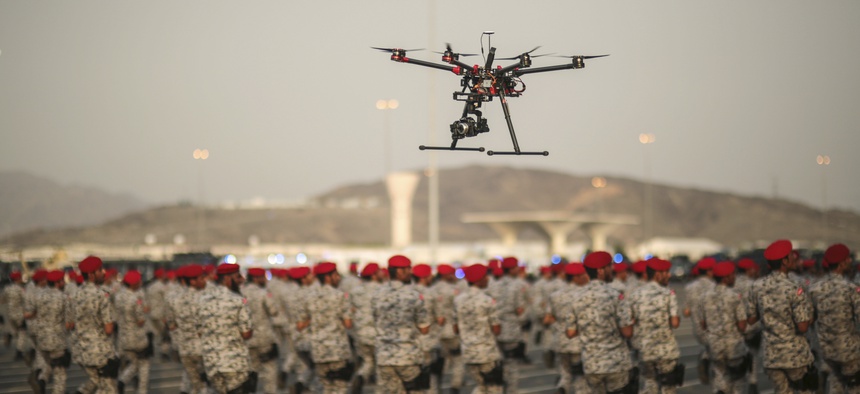 In this Thursday, Sept. 17, 2015 file photo, a drone is used to record a military parade by Saudi security forces in preparation for the annual Hajj pilgrimage in Mecca, Saudi Arabia.