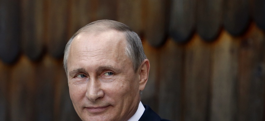 Russian Prime Minister Vladimir Putin smiles as he attends a meeting with retirees in the Kremlin in Moscow, Thursday, Nov. 17, 2011.
