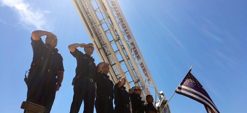 Albuquerque law enforcement officers escort the body of a New Mexico police officer who was shot and killed during a traffic stop as the procession leaves Albuquerque, N.M., Monday, Aug. 15, 2016.