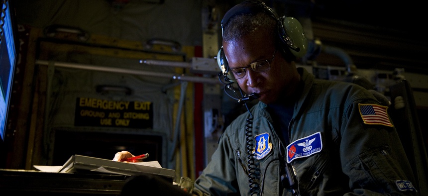 U.S. Air Force Master Sgt. Vince Burden, annotates the serial number of a dropsonde on board a WC-130J Super Hercules aircraft over the Atlantic Ocean Sept. 17, 2010.