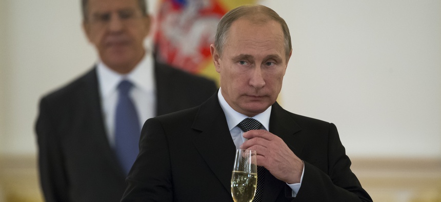 In a file photo from 2014, Russian President Vladimir Putin prepares to toast with ambassadors in the Grand Kremlin Palace in Moscow, Russia.