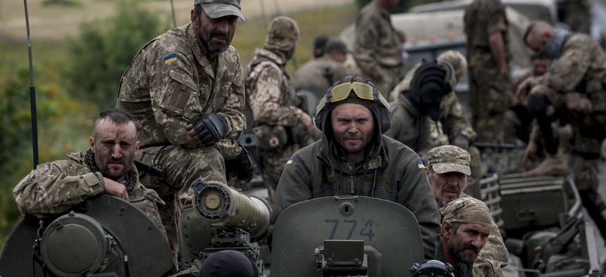 Russian-backed forces in eastern Ukraine are using rapidly innovating IT and EW tactics. Here, Ukrainian servicemen ride an armored vehicle near Krasnoarmiisk in eastern Ukraine in 2015.