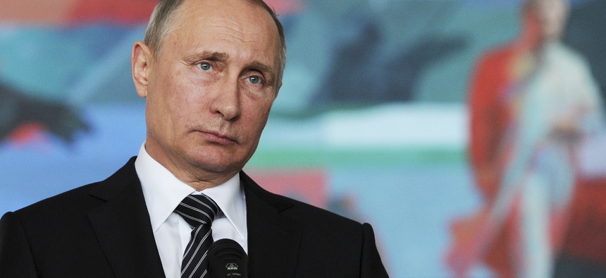 Russian President Vladimir Putin listens to a journalist's question during a news conference in Bishkek, Kyrgyzstan, Sept. 17, 2016.