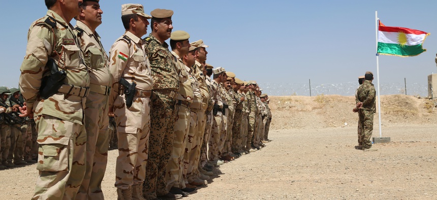 Peshmerga troops stand in formation during the Modern Brigade Course 2 graduation ceremony at the Menila Training Center, Iraq, July 28, 2016.