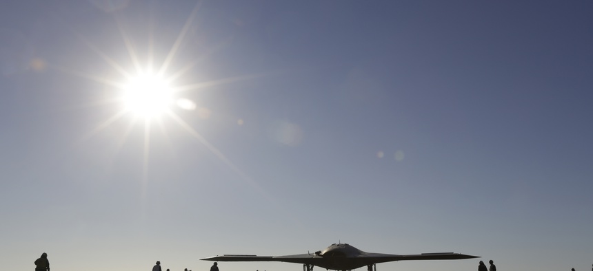 The Navy experimental unmanned aircraft, the X-47B, taxies to it's launch position on the flight deck aboard the nuclear powered aircraft carrier USS Theodore Roosevelt, off the Virginia coast, Sunday, Nov. 10, 2013.