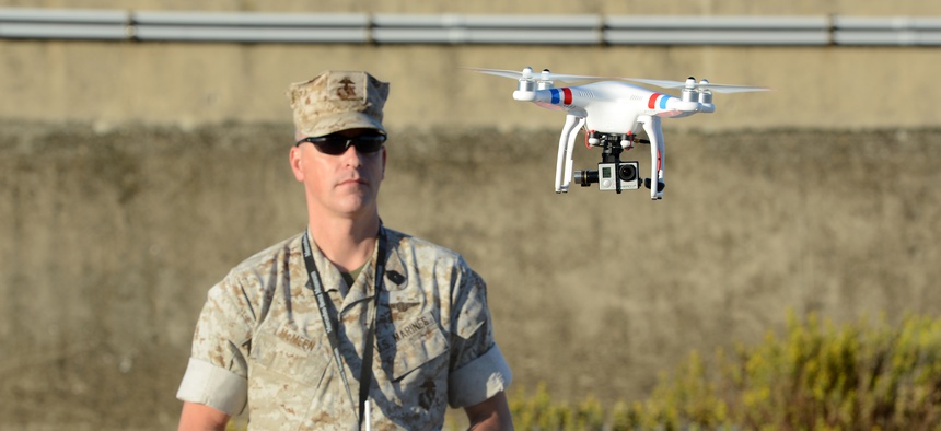 A U.S. Marine uses a commercial-grade Quadcopter to capture aerial video footage of the USNS William R. Button on the pier in Rota, Spain, during the preparation phase of Trident Juncture 2015.