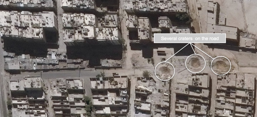 This satellite images released by the United Nations, shows road damage and craters, in the Sha'ar district of Aleppo, Syria, Sept. 25, 2016.