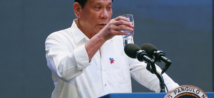 Philippine President Rodrigo Duterte makes a toast during his address to a Filipino business sector in suburban Pasay city south of Manila, Philippines Thursday, Oct. 13, 2016.