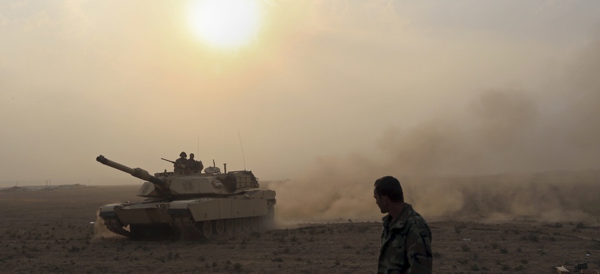 Iraq's elite counterterrorism forces prepare to attack Islamic State positions as fighting to retake the extremist-held city of Mosul enters its second week, in the village of Tob Zawa, outside Mosul, Monday, Oct. 24, 2016.