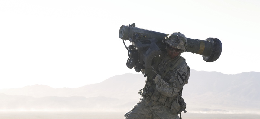A U.S. Soldier assigned to 1st Battalion, 12th Cavalry Regiment, 3rd Brigade Combat Team, 1st Cavalry Division, carries a Javelin shoulder-fired anti-tank missile during Decisive Action Rotation 17-01 at the National Training Center in Fort Irwin, Calif.,