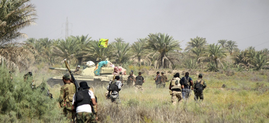 Iraqi security forces backed by allied Shiite Popular Mobilization forces and Sunni tribal fighters prepare to attack Islamic State positions at Khalidiya Island in Anbar province, Iraq, Monday, Aug. 1, 2016.