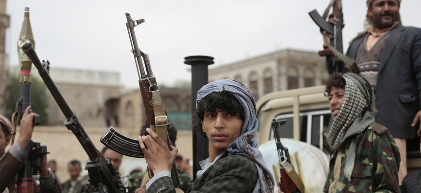 Tribesmen loyal to Houthi rebels hold their weapons as they ride on the back of a truck during a gathering aimed at mobilizing more fighters into battlefronts in several Yemeni cities, in Sanaa, Yemen, Thursday, Nov. 10, 2016.