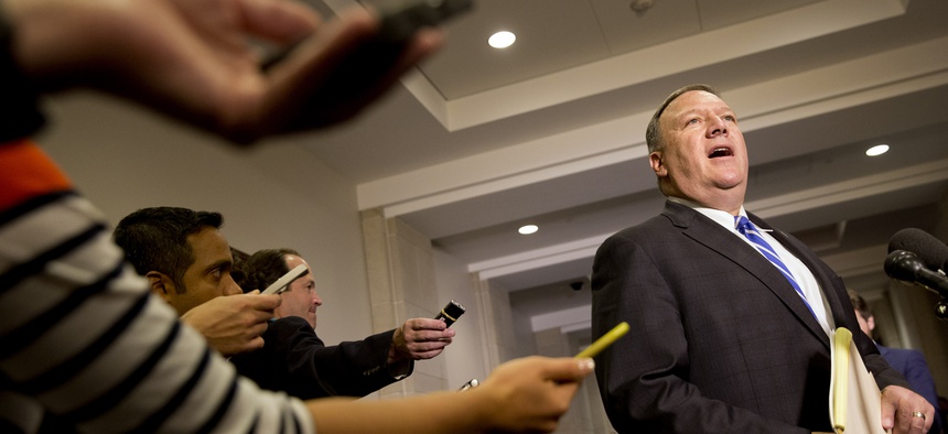 Reporters hold out recorders as House Benghazi Committee member Rep. Mike Pompeo, R-Kansas, speaks to the media on Capitol Hill in Washington, Friday, Oct. 16, 2015.