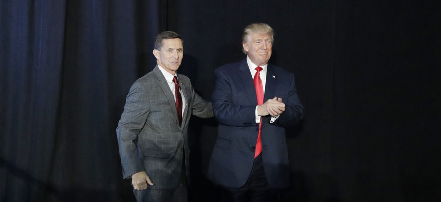 Retired Gen. Michael Flynn, left, introduces then-Republican presidential candidate Donald Trump at a campaign rally, Thursday, Sept. 29, 2016, in Bedford, N.H.