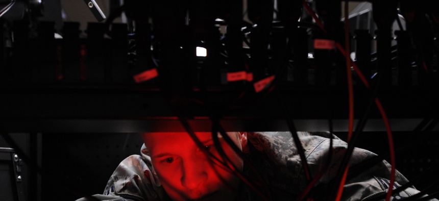 An Airman installs computer systems on the operations floor of the new 497th Intelligence, Surveillance, and Reconnaissance Group building at Langley Air Force Base, Va., April 21, 2010.