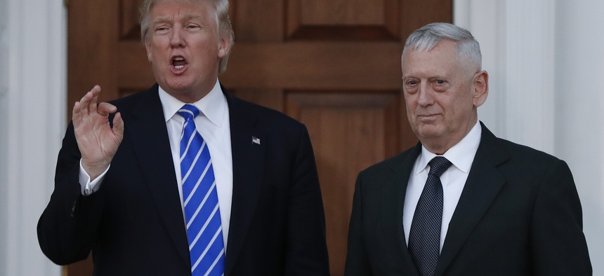 President-elect Donald Trump talks to the media as he stands with retired Marine Corps Gen. James Mattis at the Trump National Golf Club Bedminster clubhouse in Bedminster, N.J., Saturday, Nov. 19, 2016.