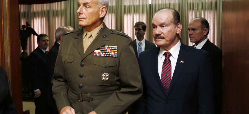 U.S. Marine Gen. John F. Kelly, commander of U.S. Southern Command, arrives for a press conference accompanied by Paraguay's Defense Minister Gen. Bernardino Soto, in Asuncion, Paraguay, Wednesday, July 30, 2014.