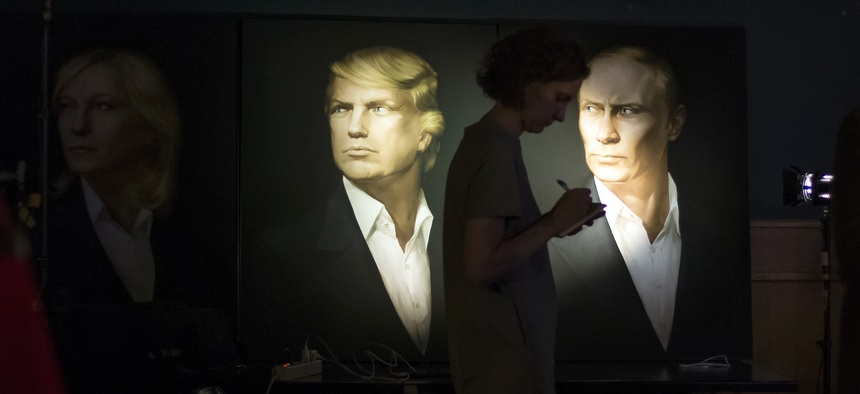A woman passes by portraits of U.S. presidential candidate Donald Trump and Russian President Vladimir Putin in the Union Jack pub in Moscow, Russia, Wednesday, Nov. 9, 2016.