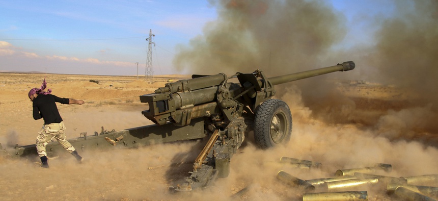 Syrian government troops fire at Islamic State group positions near Mahin, Syria, Jan. 30, 2016.