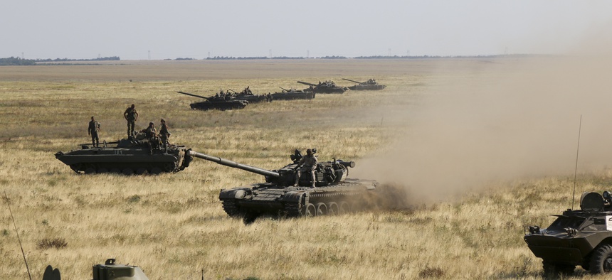 Ukrainian tanks and APCs move towards the de-facto border with Crimea near Kherson, southern Ukraine, Friday, Aug. 12, 2016.
