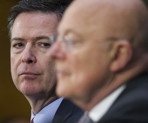 FBI Director James Comey listens at left as National Intelligence Director James Clapper testifies on Capitol Hill in Washington, Tuesday, Jan. 10, 2017, before the Senate Intelligence Committee hearing on Russian Intelligence Activities.