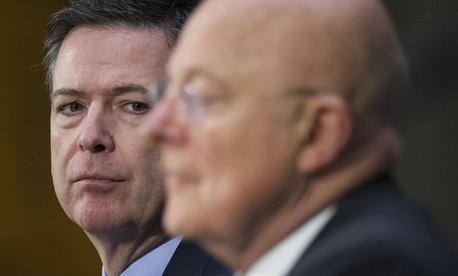 FBI Director James Comey listens at left as National Intelligence Director James Clapper testifies on Capitol Hill in Washington, Tuesday, Jan. 10, 2017, before the Senate Intelligence Committee hearing on Russian Intelligence Activities.