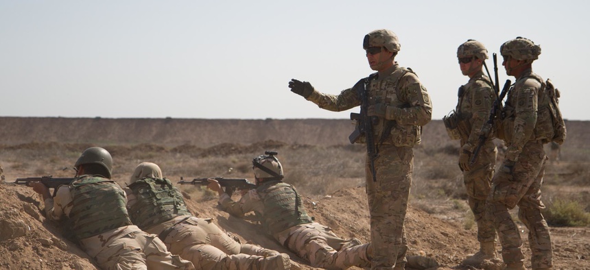 U.S. soldiers from the 82nd Airborne Division train Iraqi soldiers during a live-fire movement exercise at Camp Taji, Iraq, April 12, 2015.