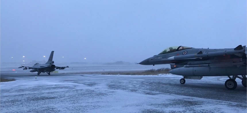 Two Norwegian Air Force jets taxi onto the runway at Bodø, Norway, in a demonstration of their ability to get airborne in less than 15 minutes.