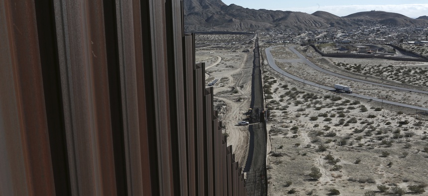 A truck drives near the Mexico-US border fence, on the Mexican side, separating the towns of Anapra, Mexico and Sunland Park, New Mexico, Wednesday, Jan. 25, 2017