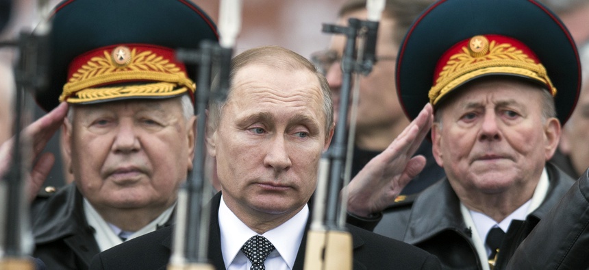 Russian President Vladimir Putin, center, attend a wreath-laying ceremony at the Tomb of the Unknown Soldier in Moscow, Russia, Tuesday, Feb. 23, 2016.