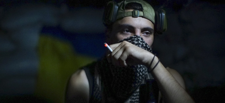 In this photo taken on Friday, Aug. 26, 2016, a Ukrainian soldier smokes in the village of Marinka, near Donetsk, eastern Ukraine. More than 9,500 people have been killed in the fighting that began in April 2014, according to United Nations figures,