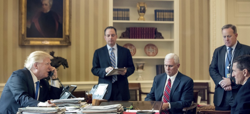 President Donald Trump, accompanied by, Chief of Staff Reince Priebus, Vice Pres. Mike Pence, Press Secretary Sean Spicer, and National Security Adviser Michael Flynn, speaks on the phone with with Russian President Vladmir Putin, Sat., Jan. 28, 2017.
