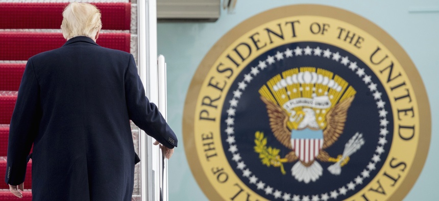 President Donald Trump walks up the steps of Air Force One at Andrews Air Force Base in Md., Friday, Feb. 17, 2017.