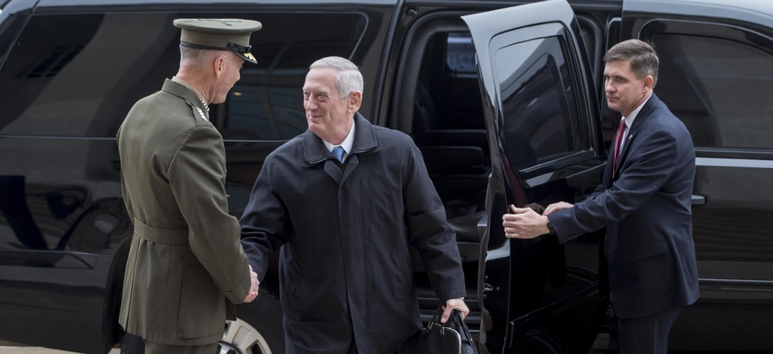 Defense Secretary Jim Mattis exchanges greetings with Marine Corps Gen. Joe Dunford, chairman of the Joint Chiefs of Staff, upon arriving at the Pentagon for his first full day as secretary, Jan. 21, 2017.