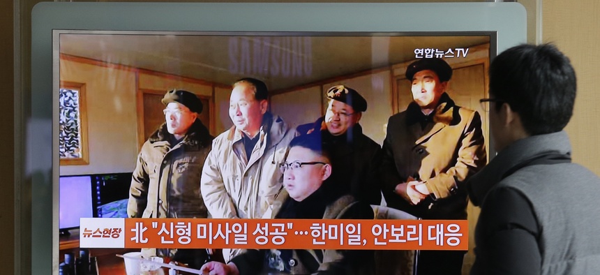 People in Seoul, South Korea watch a TV news program showing North Korean leader Kim Jong Un.