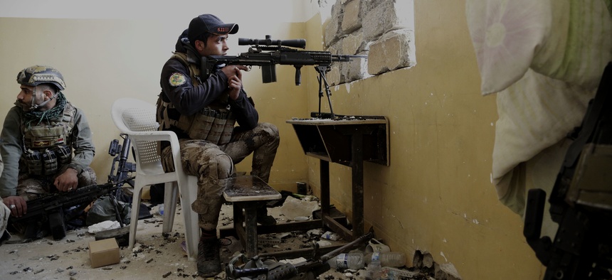 An Iraqi special forces sergeant watches the front line with Islamic State group fighters inside the Mamun neighborhood of western Mosul, Iraq, Thursday March 2, 2017.