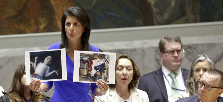 Nikki Haley, United States' Ambassador United Nations, shows pictures of Syrian victims of chemical attacks as she addresses a meeting of the Security Council on Syria at U.N. headquarters, Wednesday, April 5, 2017