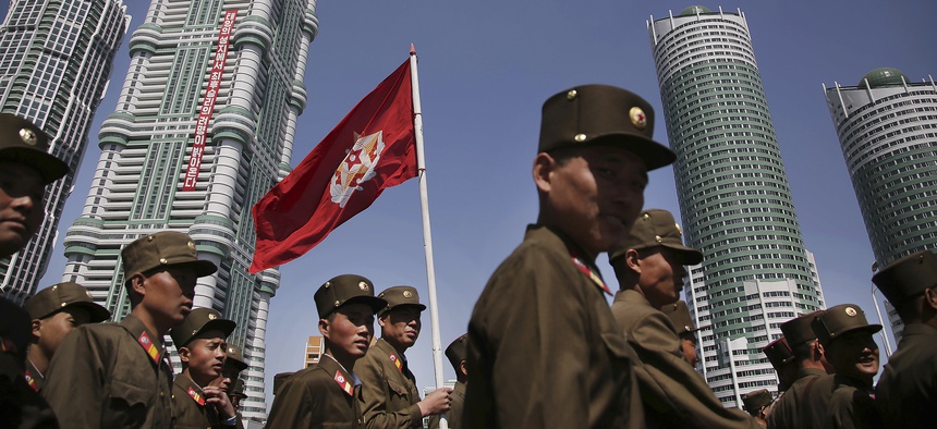 North Korean military soldiers walk along the Ryomyong residential area, a collection of more than a dozen apartment buildings just after attending its official opening ceremony on Thursday, April 13, 2017, in Pyongyang, North Korea.