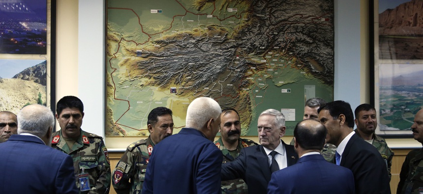 Defense Secretary James Mattis, right center, consoles outgoing Afghanistan Defense Minister Abdullah Habibi the day he resigned, at Resolute Support headquarters, Kabul, Apr 24, 2017.