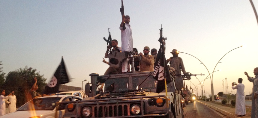 Islamic State fighters parade in a commandeered Iraqi security forces armored vehicle down a main road of Mosul, Iraq, when they controlled the city in 2014.